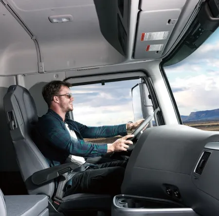 A truck driver sitting comfortably in the Hyundai XCIENT Fuel Cell Truck